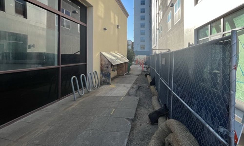 Thin alleyway behind new looking building