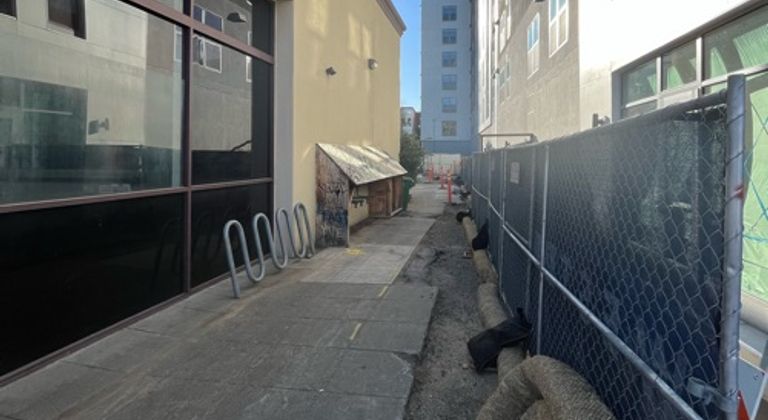 Thin alleyway behind new looking building