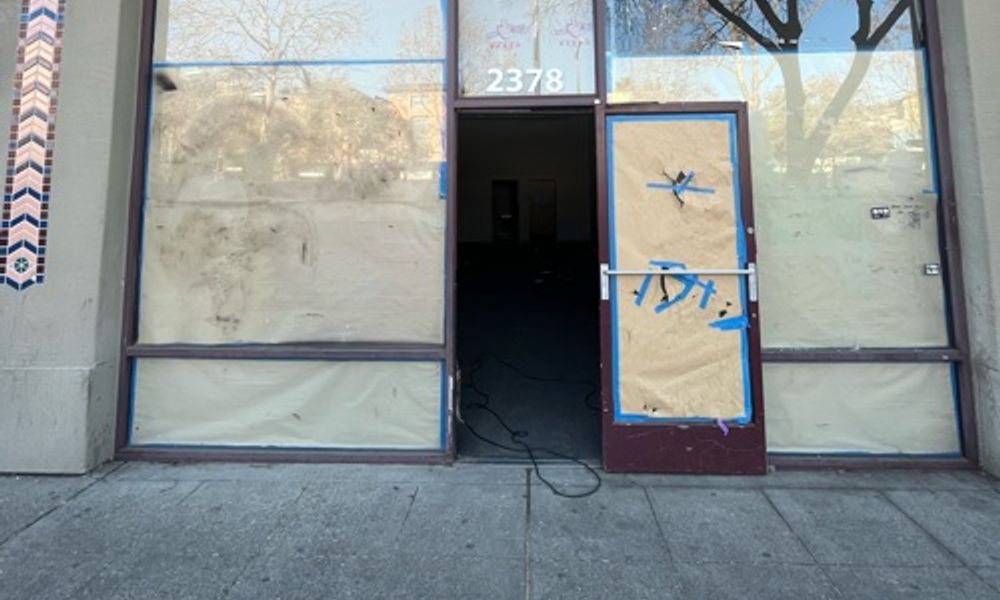 Abandoned boarded up shop