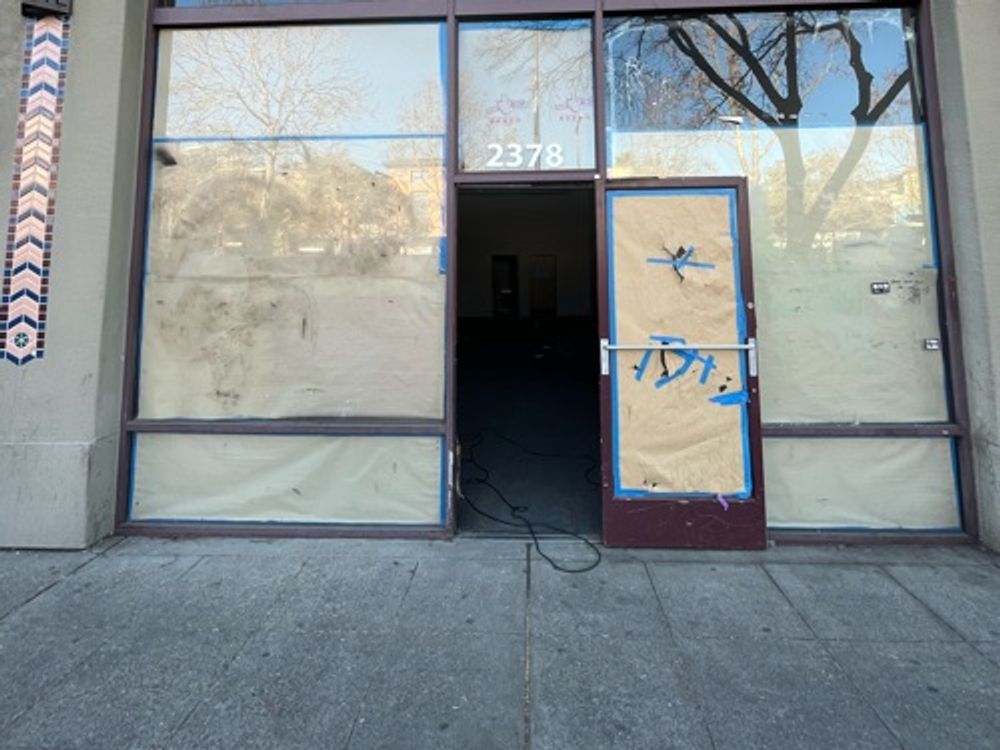 Abandoned boarded up shop — image 1