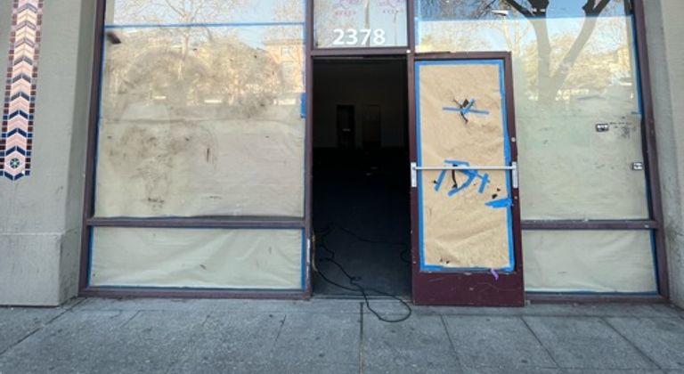 Abandoned boarded up shop