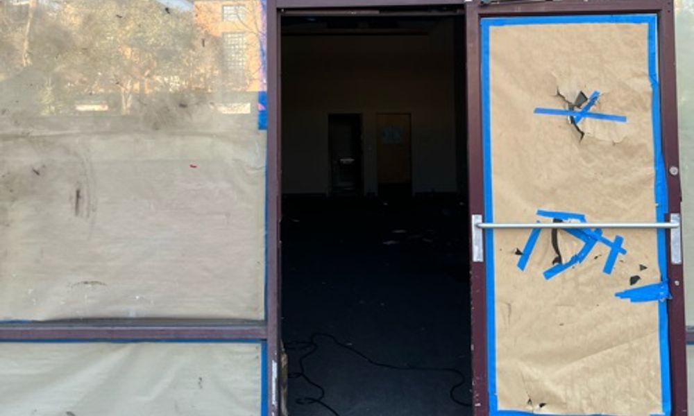 Abandoned boarded up shop