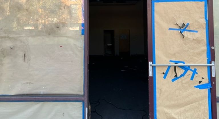 Abandoned boarded up shop